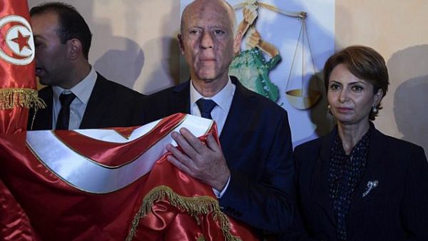 Conservative academic Kais Saied, center, flanked by his wife Ichraf Chebil, right, celebrates his victory in the Tunisian presidential election in the capital Tunis on October 13, 2019. (Fethi Belaid/AFP)