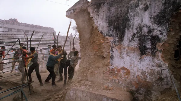 On Dec. 6, 1992, Hindu attackers hit the wall of the 16th century Babri Masjid with iron rods, part of a mob that tore down the mosque. Thousands were killed in rioting that followed the mosque's destruction. (Douglas E. Curran/AFP/Getty Images)
