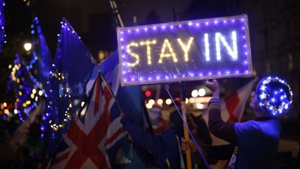 Anti-Brexit protesters with signs and EU flags lit up with fairy lights demonstrate outside the Houses of Parliament in London on September 9, 2019 as MPs debate. (AFP/ File Photo)