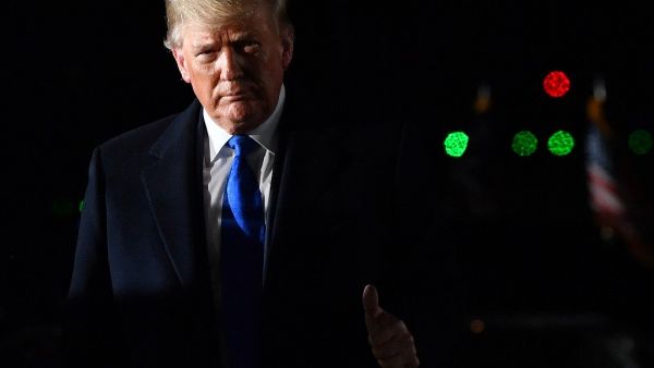US President Donald Trump gestures after disembarking from Air Force One after landing at Stansted Airport, northeast of London on December 2, 2019 (AFP/ File Photo)