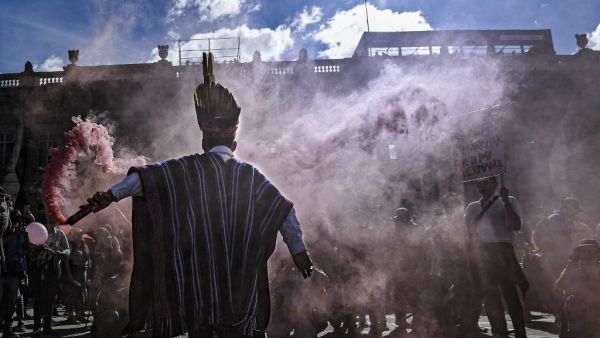 An indigenous man holds a flare during a protest against Colombian President Ivan Duque at the Bolivar square in Bogota, on December 4, 2019. (AFP/ File Photo)
