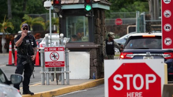 A guard stands by at the Nimitz Gate of Pearl Harbor in Hawaii shortly after a sailor fatally shot two civilians at the Pearl Harbor Naval Shipyard in Honolulu, Hawaii on December 4, 2019. (AFP/ File Photo)