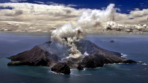 This file photo taken on November 29, 1999 shows New Zealand's most active volcano on White Island in the Bay of Plenty giving off dense plumes of steam and gas. New Zealand's White Island volcano erupted suddenly on December 9, 2019, prompting fears for a group of visitors seen walking on the crater floor moments before. TORSTEN BLACKWOOD / AFP