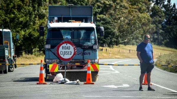 This photo taken on December 8, 2019 shows an official standing in front of a road block after the Rakaia River rose to dangerous levels, near the town of Geraldine on New Zealand's South Island. (AFP/ File Photo)