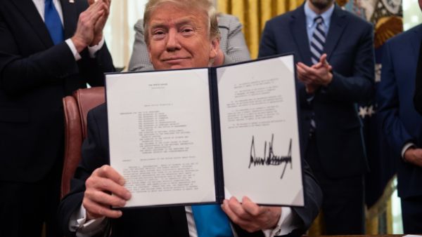 In this file photo taken on February 19, 2019, US President Donald Trump shows his signature on the Space Policy Directive-4 (SPD-4) at the White House in Washington, DC (AFP)