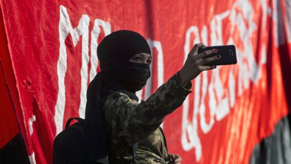 a demonstrator poses for a selfie during a protest against the government economic policies in Santiago, a day after more than one million people took to the streets for the largest protests in a week of demonstrations. AFP/ File