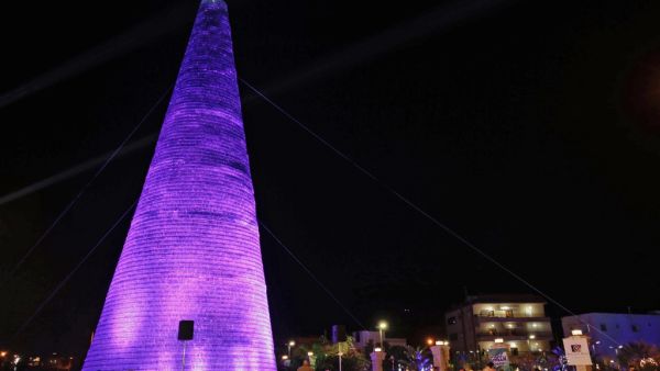 Lebanese visitors gather around a Christmas tree made of discarded plastic water bottles in the northern coastal town of Chekka, on December 15, 2019. (AFP/ File Photo)
