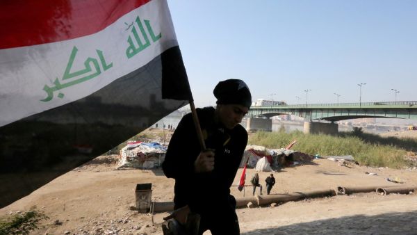 An Iraqi protestor leaves a camp site next to al-Jumhuriyah (Republic) Bridge spanning the River Tigris in the heart of Baghdad on December 18, 2019. SABAH ARAR / AFP