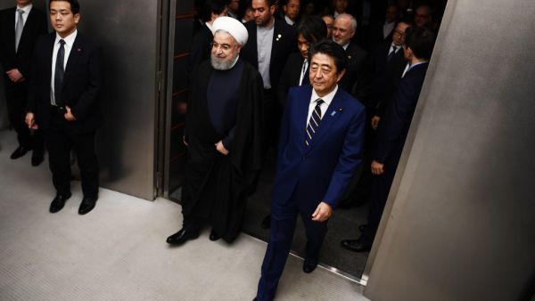 ranian President Hassan Rouhani (L) walks with Japanese Prime Minister Shinzo Abe (R) to a meeting room at the prime minister's office in Tokyo on December 20, 2019. Charly TRIBALLEAU / POOL / AFP