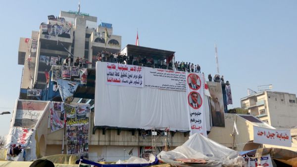 Iraqi anti-government protesters rally during ongoing demonstrations in the capital Baghdad's Tahrir square (AFP)