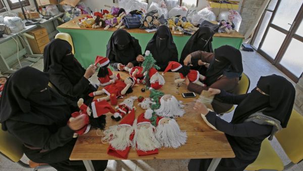 Palestinian artisans make Christmas toys at Zeina Association and Cooperative for Handicraft in Beit Hanun in the northern Gaza Strip on December 24, 2019. MOHAMMED ABED / AFP
