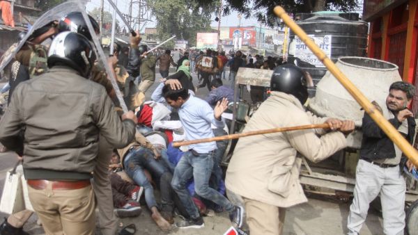 In this file picture taken on December 19, 2019, police with sticks locally known as "lathi" beat protesters during a demonstration against India's new citizenship law in Lucknow. As Indian protests against a new citizenship law have intensified, so has use of "lathis", sturdy sticks used to whack, thwack and quell dissent since British colonial times -- to sometimes deadly effect. STR / AFP