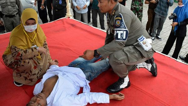 An Indonesian man is whipped in public in the Aceh province on charges of pre-marital sex on Thursday, a serious crime in the conservative region's Islamic law. AFP