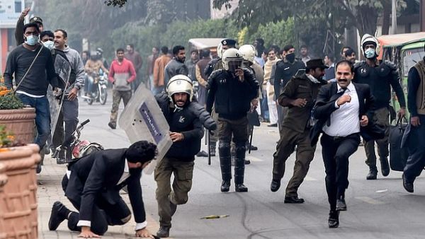Policemen chase lawyers following a clash between lawyers and doctors in Lahore today (AFP/ File Photo)