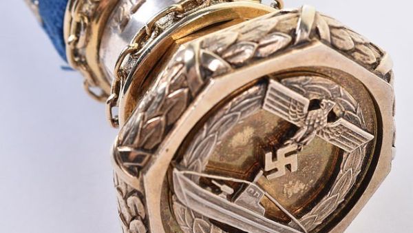 Since his original baton was taken, Donitz's naval comrades had a replica made for him. Pictured: a U-Boat war badge on the end of the item  (Dailymail)
