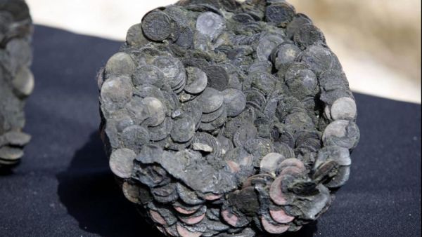 Coins from a late Roman ancient shipwreck found in 2016 off the coast of Israel. Researchers in Greece said Monday pots found from a shipwreck off the eastern Mediterranean coast are about 2,000 years old. (Photo by Abir Sultan/EPA)