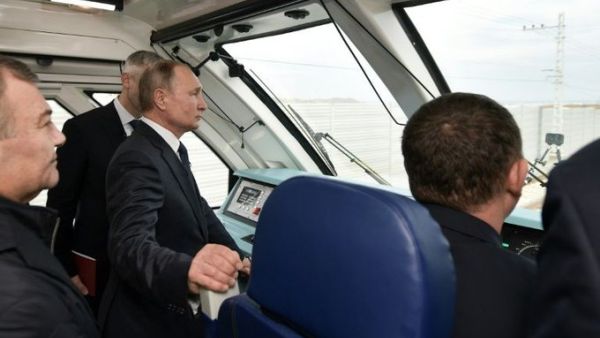 President Vladimir Putin stood in the driver's cabin of a train for the official opening of a railway bridge that links annexed Crimea to southern Russia (Twitter)