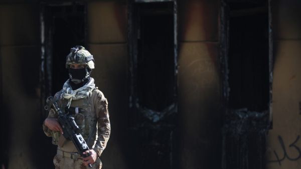 A member of Iraq's security forces stands guard in front of the US embassy in the capital Baghdad, after an order from the Hashed al-Shaabi paramilitary force to supporters to leave the compound on January 1, 2020. #FGU89 Thousands of Iraqi supporters of the largely Iranian-trained Hashed had encircled and vandalised the embassy compound yesterday, outraged by US air strikes that killed 25 fighters of the military network over the weekend. AHMAD AL-RUBAYE / AFP