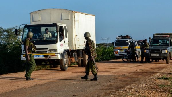 Kenyan police officers check vehicles on a road after a bus, travelling from the coastal region of Lamu to the town of Malindi, was ambushed by gunmen in Lamu county, southeast Kenya, on January 2, 2020. (AFP/ File Photo)