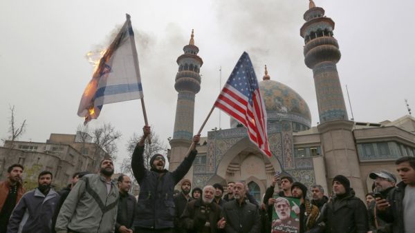 Iranians burn an Israeli and a US flag during an anti-US protest over the killings during a US air stike of Iranian military commander Qasem Soleimani and Iraqi paramilitary chief Abu Mahdi al-Muhandis, in the capital Tehran on January 4, 2020. ATTA KENARE / AFP