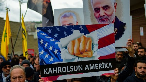 A protester holds a banner reading " down with America", during a demonstration outside the US consulate in Istanbul, on January 5, 2020, two days after top Iranian commander Qasem Soleimani was killed by a US drone strike. A US drone strike killed top Iranian commander Qasem Soleimani at Baghdad's international airport on January 3, dramatically heightening regional tensions and prompting arch enemy Tehran to vow "revenge". Yasin AKGUL / AFP