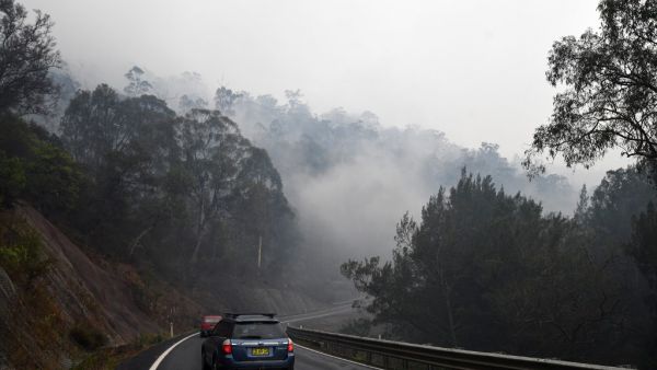 Firefighters were racing to contain massive bushfires across southeastern Australia Tuesday amid easing conditions as another heatwave loomed, as officials said the damage bill for the months-long crisis had risen to almost half a billion dollars.  SAEED KHAN / AFP
