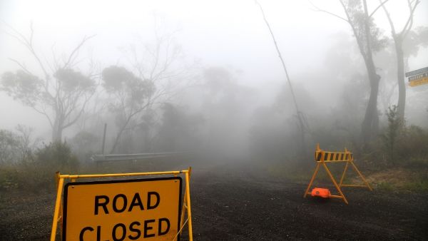 Thick fog mixed with bushfire smoke fills the sky in the Ruined Castle area of the Blue Mountains, some 75 kilometres from Sydney, on January 11, 2020. Massive bushfires in southeastern Australia have a "long way to go", authorities have warned, even as colder conditions brought some relief to exhausted firefighter and communities. SAEED KHAN / AFP