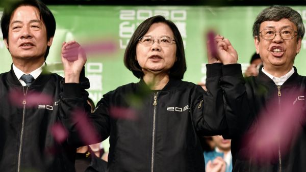 Taiwan President Tsai Ing-wen (C) joins her hands with Vice President-elect William Lai (L) and Vice President Chen Chien-jen outside the campaign headquarters in Taipei on January 11, 2020. President Tsai Ing-wen declared victory in Taiwan's election on January 11 as votes were being counted after an election battle dominated by the democratic island's fraught relationship with China.  Sam Yeh / AFP