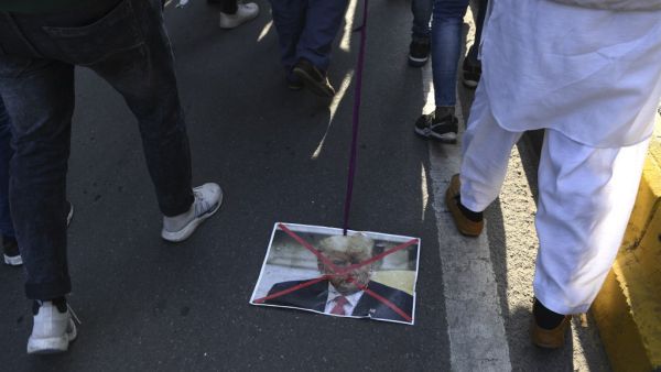 A Muslim protester drags a placard of US president Donald Trump during a protest against the US military action for the killing of the top Iranian general Qasem Soleimani in Iraq, during a demonstration in New Delhi on January 12, 2020. Sajjad HUSSAIN / AFP