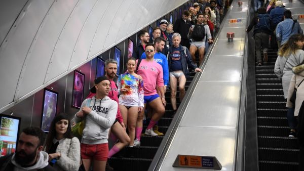 People use an escalator as they take part in the annual 'No Trousers On The Tube Day' (No Pants Subway Ride) on the London Underground in central London on January 12, 2020.  (AFP/ File Photo)