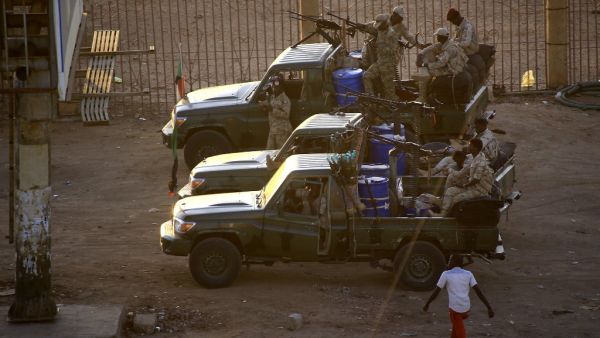 Members of Sudan's intelligence services shoot bullets in the air at the headquarters of the Directorate of General Intelligence Service, in the Riyadh district of the capital Khartoum, on January 14, 2020. Heavy gunfire broke out in Sudanese capital as several agents of the long-feared security agency launched a "rebellion" against a restructuring plan, prompting a closure of the international airport. ASHRAF SHAZLY / AFP