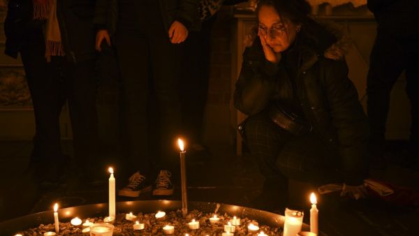 A mourner gathers at a memorial service for the victims of Ukrainian Airlines flight PS752 crash in Iran at Storkyrkan church in Stockholm on January 15, 2020.  Jonathan NACKSTRAND / AFP