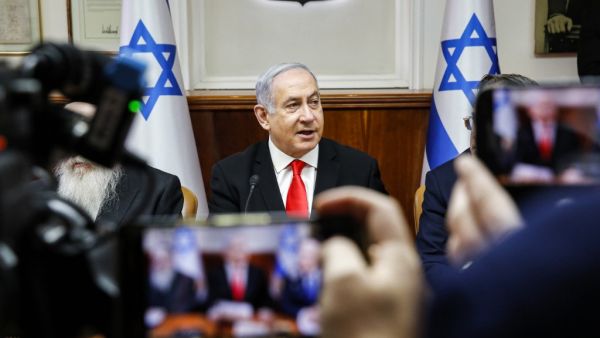 Israeli Prime Minister Benjamin Netanyahu is filmed by journalists as he attends the weekly cabinet meeting at his office in Jerusalem on January 19, 2020. GIL COHEN-MAGEN / POOL / AFP