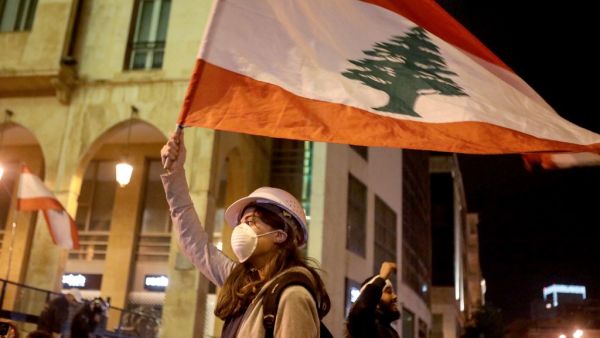 Lebanese protestors wave flags and shout anti-corruption slogans outside the parliament during a protest in downtown Beirut on January 21, 2020. (AFP/ File Photo)