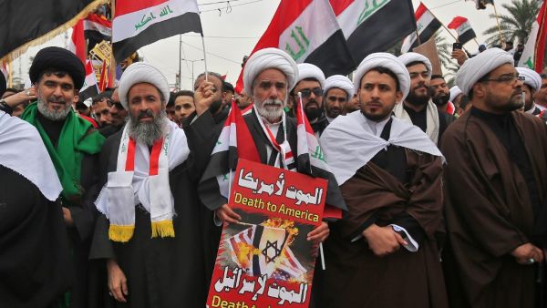 Shiite Muslim clerics carry a placard as supporters of Iraqi cleric Moqtada Sadr gather in the capital Baghdad for a "million-strong" march to demand an end to the presence of US forces in their country, on January 24, 2020. (AFP/ File Photo)