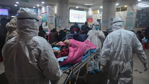 In this photo taken on January 25, 2020, medical staff wearing protective clothing to protect against a previously unknown coronavirus arrive with a patient at the Wuhan Red Cross Hospital in Wuhan. (AFP/ File Photo)
