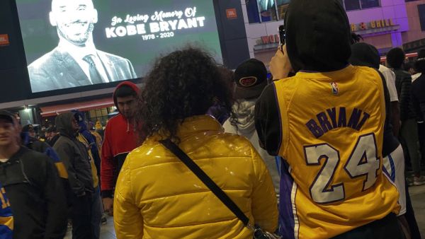 People gather by the Staples Center in Los Angeles on January 26, 2020 as they pay tribute to former NBA and Los Angeles Lakers player Kobe Bryant following his death in a helicopter crash near Los Angeles. (AFP/ File Photo)
