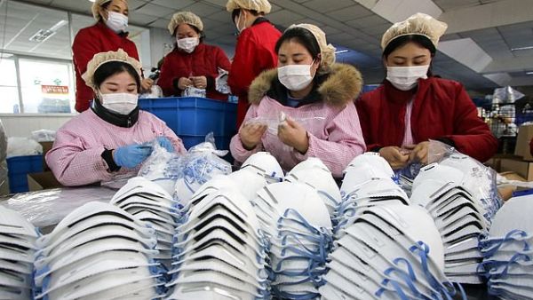 In the picture taken yesterday, workers are seen producing face masks at a factory in Handan in China's northern Hebei province. (AFP/ File Photo)