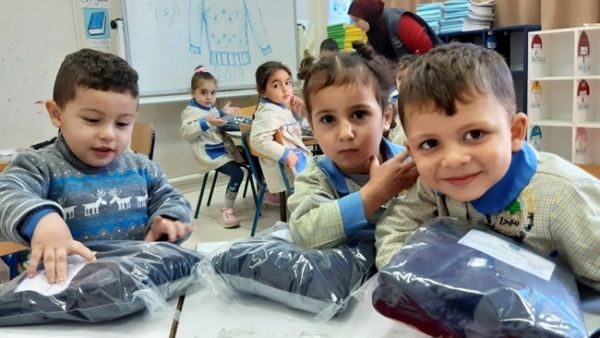 Students receive sweaters in Sidon, Dec. 21, 2019. (The Daily Star/Mohammed Zaatari)