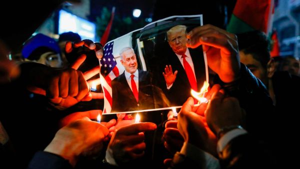 Palestinian protesters burn pictures of US President Donald Trump and Israel's Prime Minister Benjamin Netanyahu during a demonstration in the West Bank against the expected peace plan proposal AFP via Getty