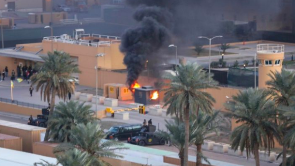A sentry box burns at an entrance to the United States embassy in the Iraqi capital Baghdad (AFP File Photo)