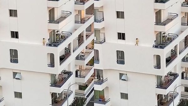 The child jumps as she appears to lose her footing (pictured) and races back along the ridge, before stopping at the window where the footage ends. (Facebook)