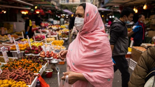 A woman wearing a protective face mask shops at a fresh food market in Hong Kong on February 9, 2020, as a preventative measure after a coronavirus outbreak which began in the Chinese city of Wuhan. AFP