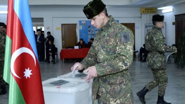 Azerbaijan's servicemen vote at a polling station during the parliamentary elections in Baku on February 9, 2020. Azerbaijan on Sunday holds snap parliamentary elections denounced by opposition parties as a feint aimed at further strengthening authoritarian President Ilham Aliyev's tight grip on power. TOFIK BABAYEV / AFP