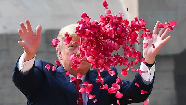 US President Donald Trump sprays rose petals to pay tribute at Raj Ghat, the memorial for Indian independence icon Mahatma Gandhi, in New Delhi on February 25, 2020. Mandel NGAN / AFP