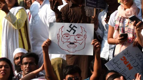 Protesters hold placards during a demonstration against India`s new citizenship law in Mumbai on 27 December, 2019. Photo: AFP