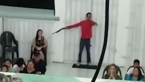 Police in the northwestern Brazilian city of Manaus are looking for two men, including one (pictured) who was caught on video pointing a gun at a woman inside a church Sunday night. (Video Screenshot)