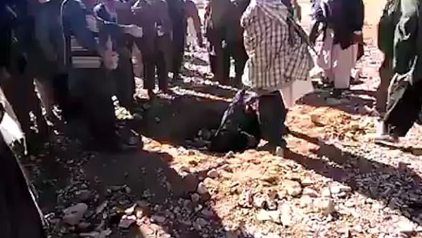 The woman appeared to be dumped in a pit before the stoning began. The punishment was frequently used against convicted adulterers when the Taliban ruled the country. (Video Screenshot)