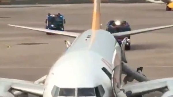 Pictured: The plane after the wheel was set alight in an incident on the runway in Dusseldorf today. (Twitter)