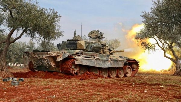 Syrian rebels fire from position in countryside of Idlib towards government forces on Sunday (AFP)